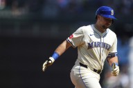 Cal Raleigh hits his 48th, 49th homers to set MLB season mark for catchers, passing Salvador Perez