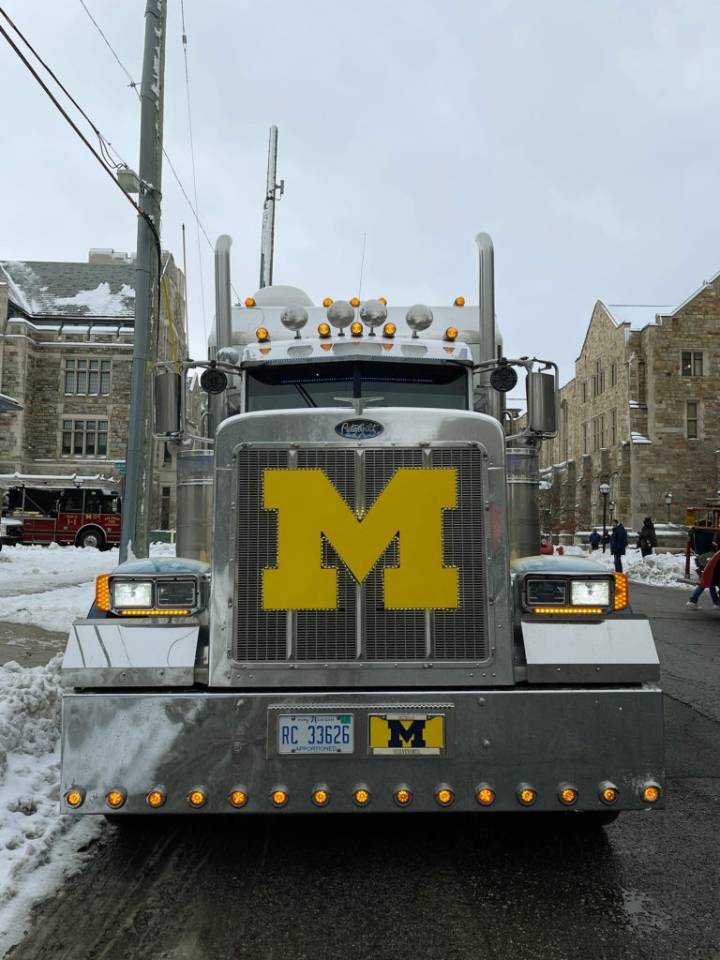 NCAA fines Michigan millions, suspends Moore 3 games over sign