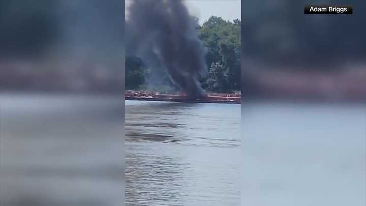 Two die when helicopter strikes powerlines and crashes into a barge on the Mississippi River