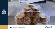 Traveller caught by CBSA carrying 18 kilos of cocaine in cheese cans