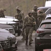 Australian police urge gunman to surrender after officers killed