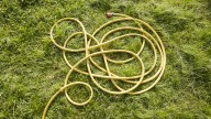 Repurpose A Common Thrift Store Find To Make Your Garden Hose Less Of An Eyesore