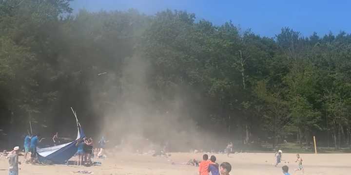 Watch: Children on New York beach run screaming from dust devil
