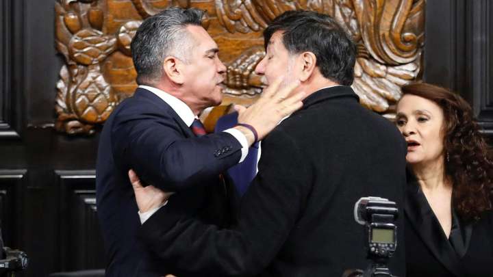 Brawl in Mexican parliament sees lawmakers shove each other and photographer pushed over as row breaks out over cartels