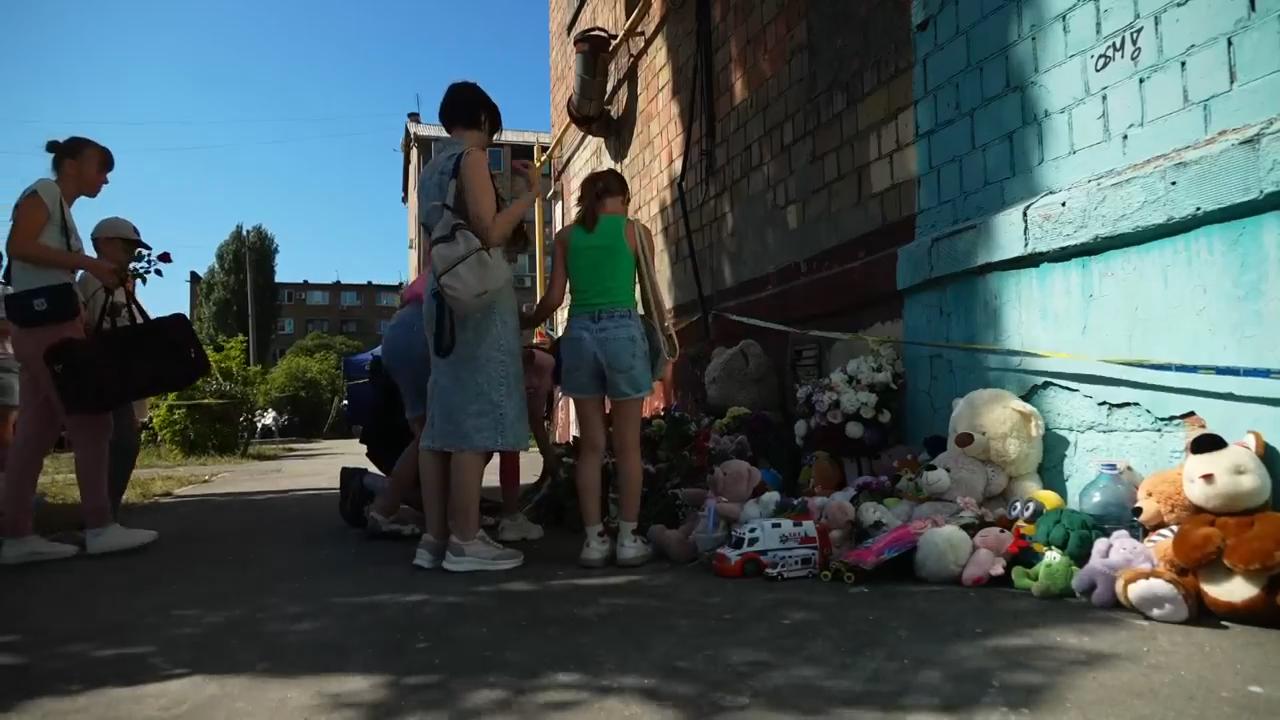 Kyiv resident recalls moment of Russian attack as toys and flowers are left for those who died