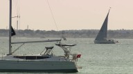 Person pulled from water after boat capsizes off Massachusetts beach dies, state police say