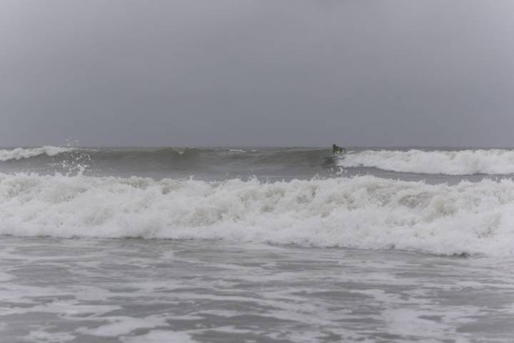 OC beach patrol pulls child, warns public as hurricane drives surf on boardwalk, dunes