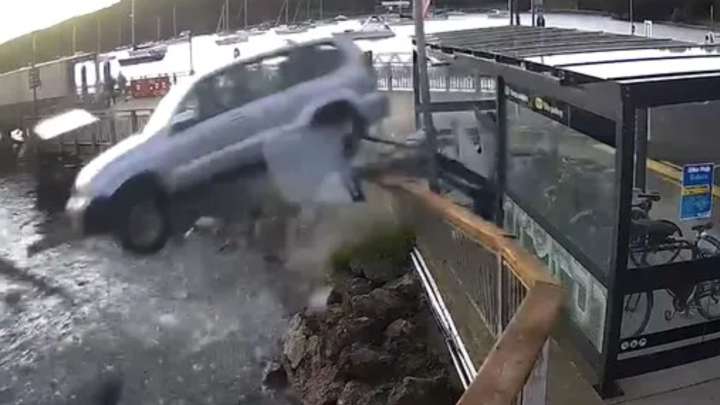 Terrifying moment drunk OAP drives off wharf into sea sparking frantic rescue before car is swallowed up by the waves