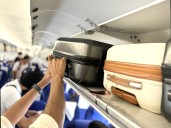 The Secret Way to Always Get Overhead Bin Space on a Flight, According to Travel Pros