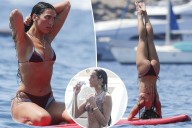 Dua Lipa flaunts her abs during paddleboard yoga in Ibiza