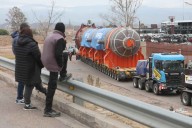 Carteles suspendidos en el aire y las reacciones de la gente ante el paso del reactor de Impsa