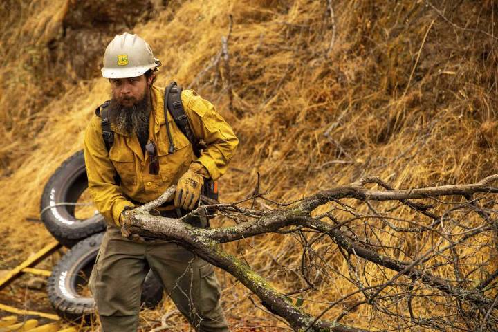 Firefighters try to corral California forest blaze as lightning strikes bring risk of new ignitions