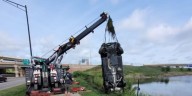Two people receive minor injuries after a vehicle submerged in a pond