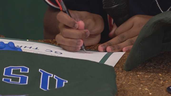 Signing 'A Holy Moment' for Central Georgia students' college dreams at GCSU