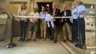 Former facilities manager Bob Robins helps riders take first elevator ride since reopening