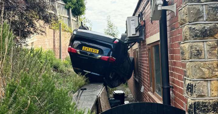 Runaway car flips upside down and crashes into gym window