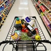 US indices power to fresh records after benign inflation data