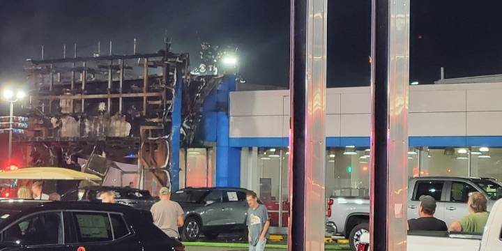 Crews fight fire at auto dealership