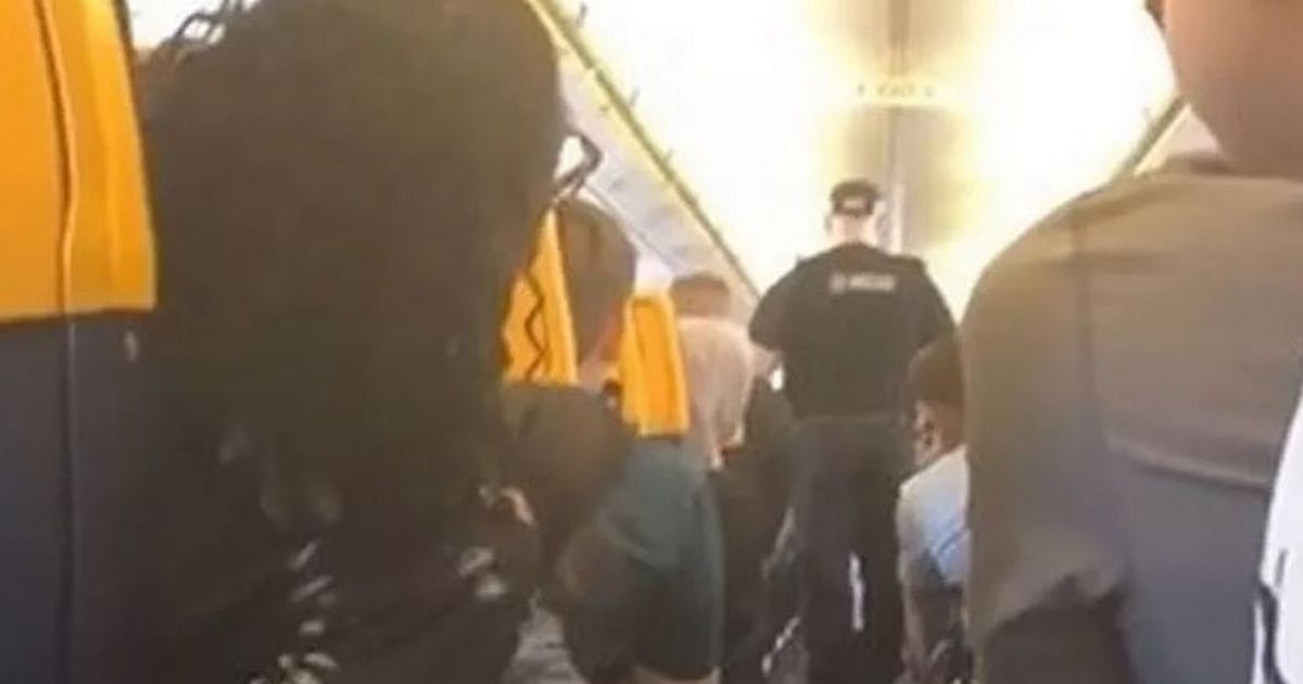 Cops board Ryanair flight after passenger 'tries to open emergency exit' mid