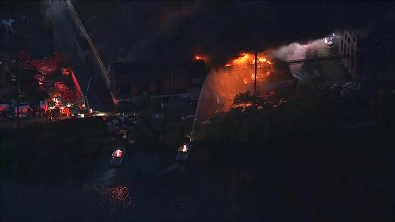 Firefighters battle a 5-alarm fire at a Philadelphia warehouse