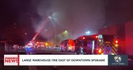 Firefighters battle large warehouse fire east of downtown Spokane