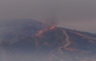 News Wrap: Thousands forced to flee Canyon Fire in mountains near LA