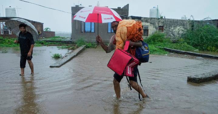 Photos show people fleeing flooding in Kashmir after weeks of intense rain in the region