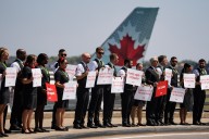 Air Canada flight attendants picket at 4 major airports in what union calls national day of action