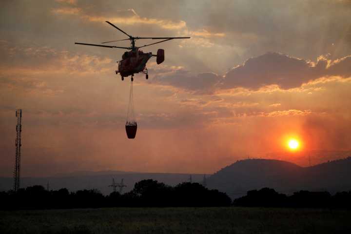 Wildfires burn in Europe as record summer heat simmers