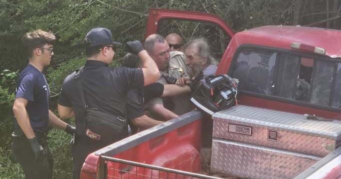 Truck leaves highway and driver fights emergency personnel trying to rescue him
