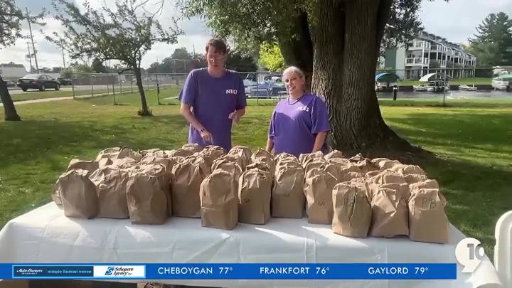 Two developmentally impaired adults start up a sack lunch program for those in need