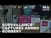 Surveillance captures gunman ordering Pigtown shop owner to the ground in armed robbery
