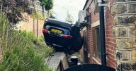 Runaway car flips upside down and crashes into gym window