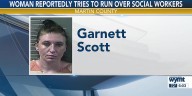 Woman accused of trying to run over social workers