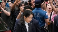 South Korean investigators seek arrest of wife of jailed ex