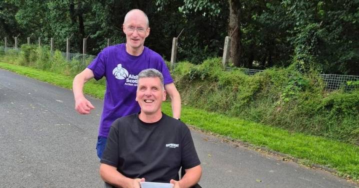 Heartwarming moment Scot completes 'wheelchair marathon' pushing mum with Alzheimer's
