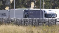 13 freezing UK-bound migrants found trapped in fridge lorry after driver heard them ‘screaming for help’ near Calais