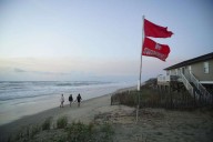 Summer celebrations meet closed beaches and warnings on US East Coast due to Hurricane Erin