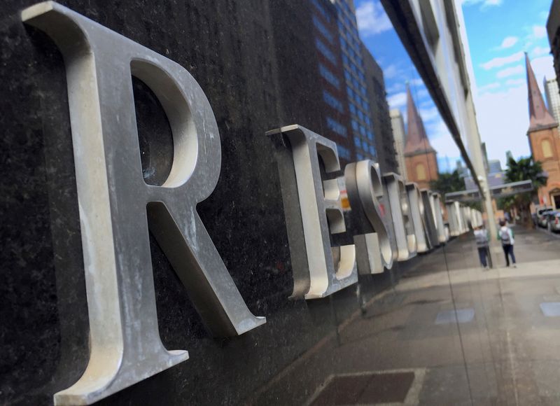 Australia's central bank cuts rates, still cautious about outlook