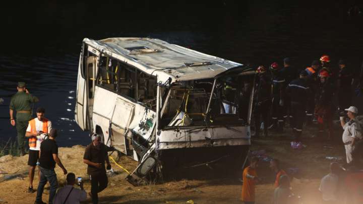 At least 18 dead and nine injured after bus plunges from bridge into a river after veering off the road in Algeria