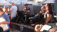 Bikers help giveaway 200 free backpacks to families recovering from floods