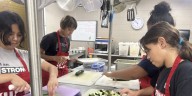 Young ladies at Girls Inc. prep for a ‘Farm to Table’ meal for a community fundraiser