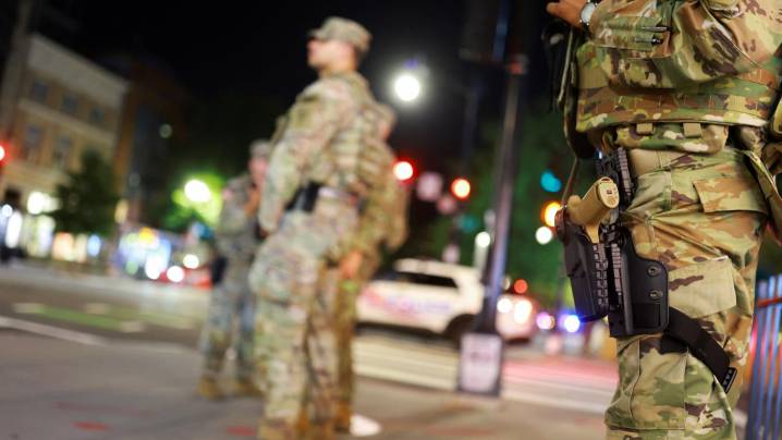 National Guard troops in Washington, DC, begin carrying weapons
