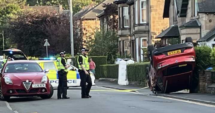 Glasgow road locked down after horror smash sees car flip onto roof