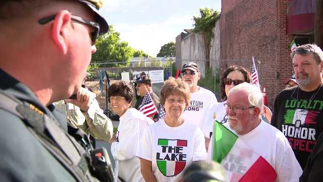 Police order crowd to move as DPW removes Italian colors from Nonantum street