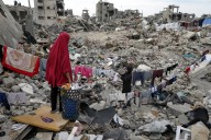Members of the Nijim family hang laundry on the ruins of their Jabaliya house in February, amid widespread destruction caused by the Israeli military's ground and air offensive in the Gaza Strip. A ne