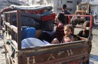 Families leave Gaza City after night of bombardment, Israelis protest
