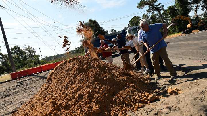 Scenes from roundabout groundbreaking at River Road in…