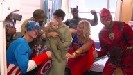 Window-washing superheroes bring smiles to young patients' faces