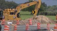 Crews lay pipes to distribute alternative water supply throughout Polk County